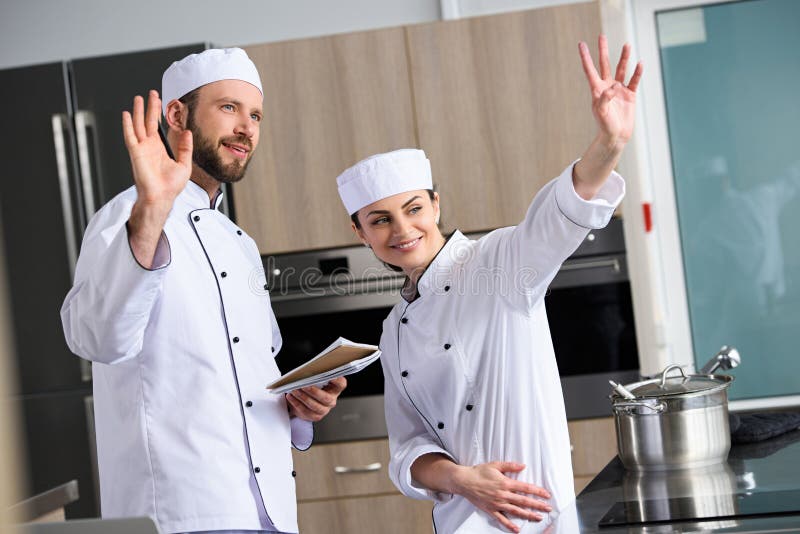 Chefs waving hands stock photo. Image of interior, caucasian 127722156