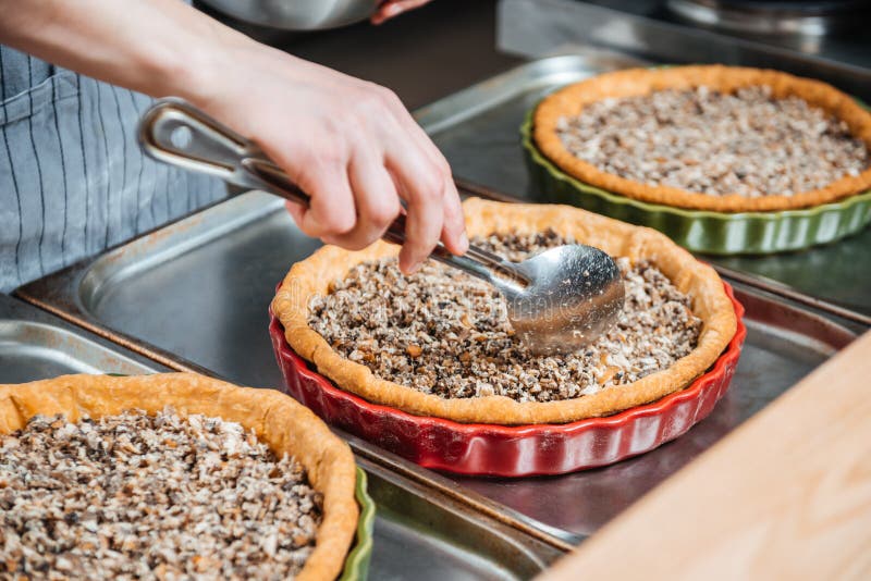 Cheif Cook Making Pie with Meat Filling on the Kitchen Stock Image
