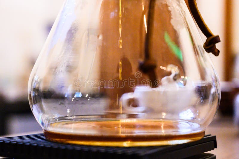 Chemex pour over coffee brewing in glass carafe stock photography