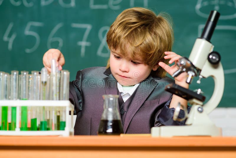 Chemical analys Litet barnsnille behandla som ett barn Pojkebruksmikroskop och provrör i skolaklassrum Retro laboratoriumutrustni arkivfoton Chemical analys Litet barnsnille behandla som ett barn Pojkebruksmikroskop och provrör i skolaklassrum Retro laboratoriumutrustni arkivfoton