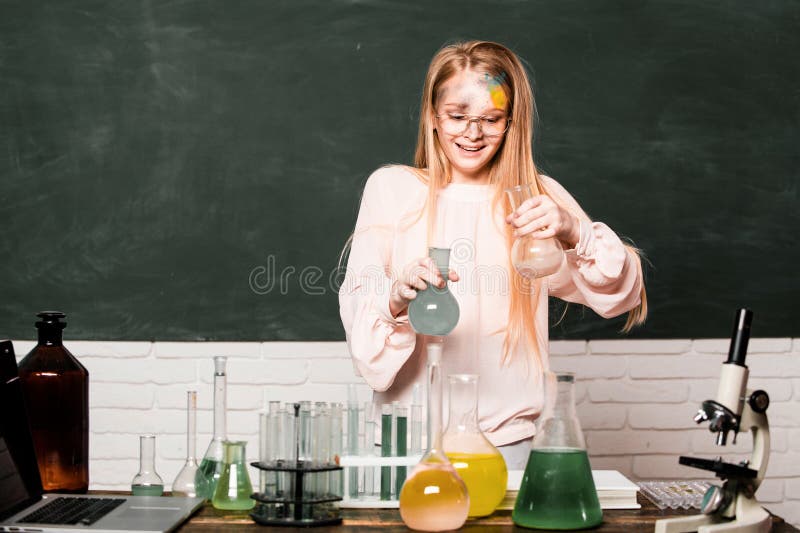 Chemical experiment. Funny schoolgirl kid doing experiments in the laboratory. Explosion in the lab. Science and education. Little girl chemical scientist in the laboratory