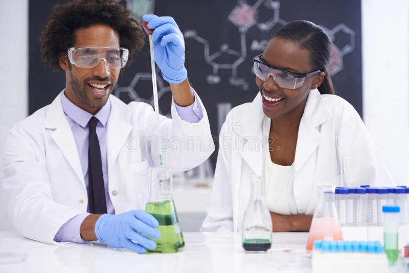 Chemical fun. two scientists conducting an experiment with various chemicals. stock image