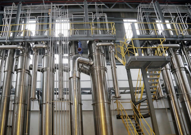 A complex network of pipes and vessels in a modern chemical processing facility stock image