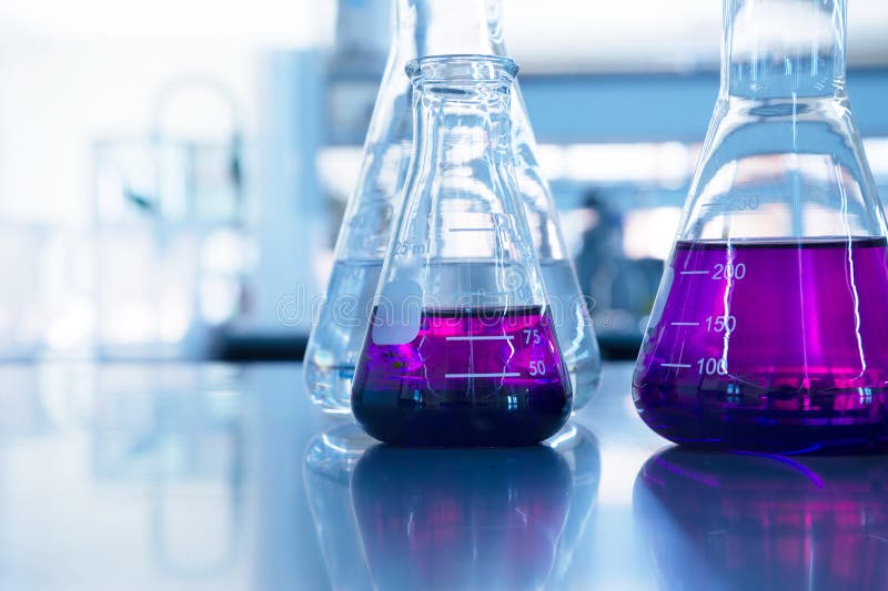 Chemical purple water solution in glass flask at education science laboratory background stock photography Chemical purple water solution in glass flask at education science laboratory background stock photography