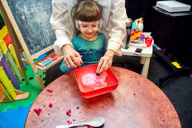 Chemical show for kids. Professor carried out chemical experiments with liquid nitrogen on Birthday little girl. stock image Chemical show for kids. Professor carried out chemical experiments with liquid nitrogen on Birthday little girl. stock image