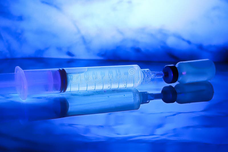 Chemicals Glowing Under Blacklight Against a Blue Background Stock
