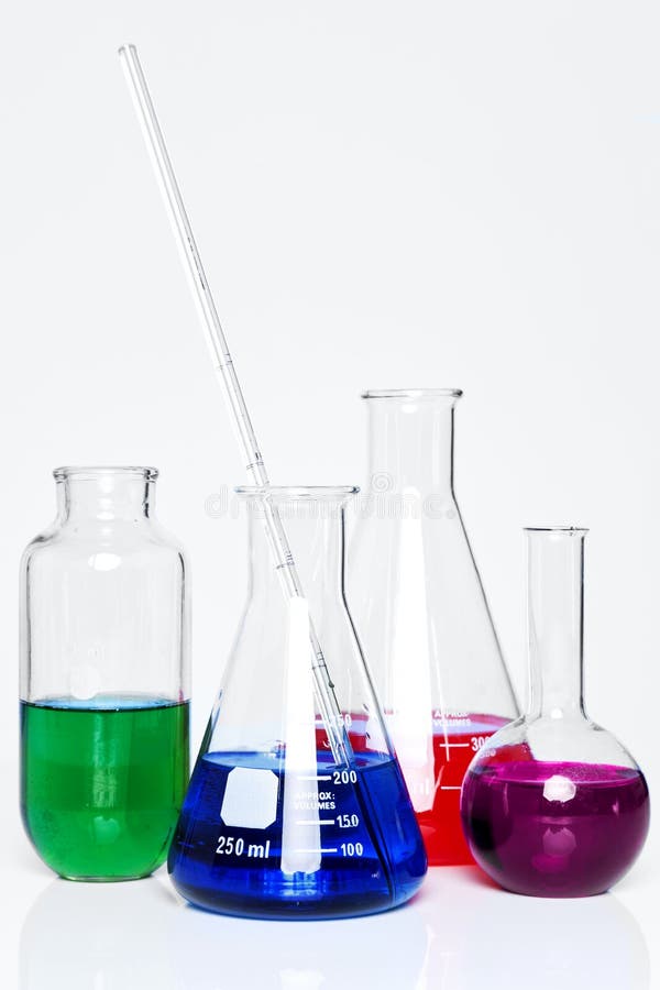 Photo of chemistry flasks full of chemicals on a plain background. Photo of chemistry flasks full of chemicals on a plain background.