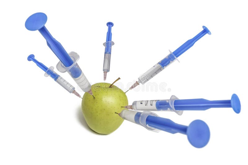 Chemicals in food concept. Syringes and apple. Isolated on white background. Chemicals in food concept. Syringes and apple. Isolated on white background.