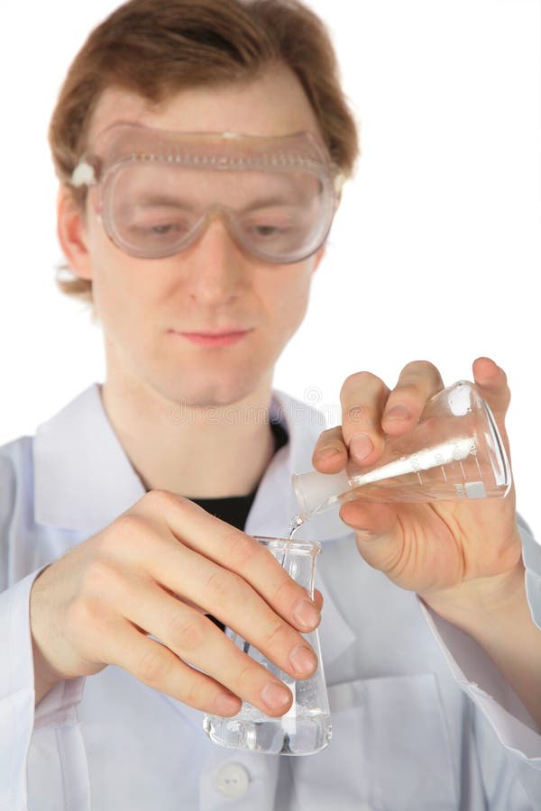 Chemist pours liquid from flask in another