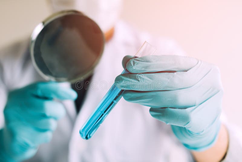 Chemist or Scientist Using Magnifying Glass Dispense the Solutio Stock Photo Image of doctor