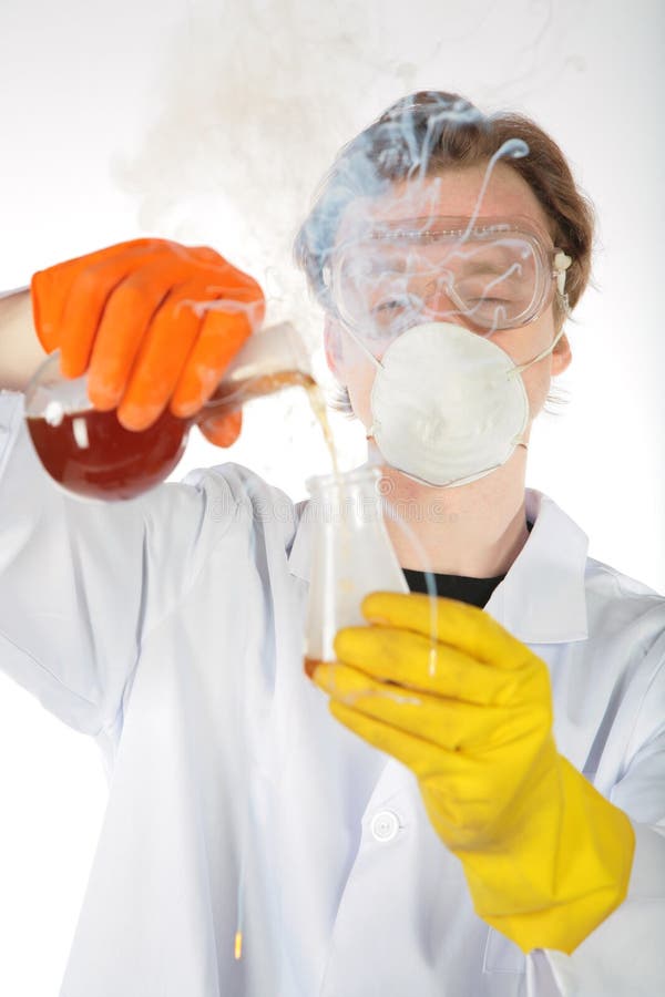 Chemist in smoke pours liquid in a flask