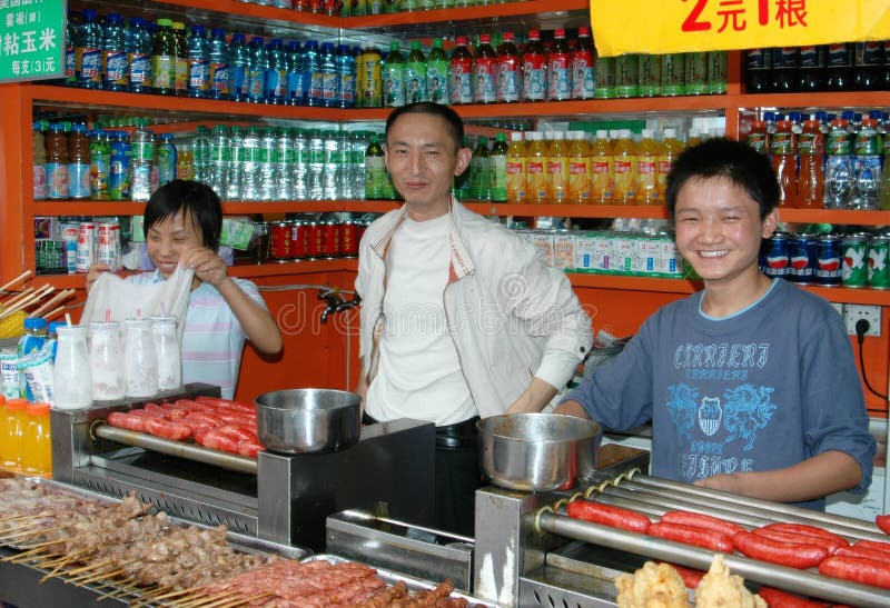 Friendly workers at a family owned and run food shop on Qing Nian Lu (street) selling teas, sodas, and a wide array of delicious barbecued meats and sausages in Chengdu, China. Friendly workers at a family owned and run food shop on Qing Nian Lu (street) selling teas, sodas, and a wide array of delicious barbecued meats and sausages in Chengdu, China.