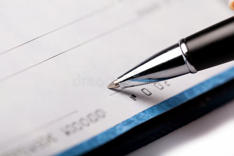 Woman`s Hand Writing a Check - Close Up.