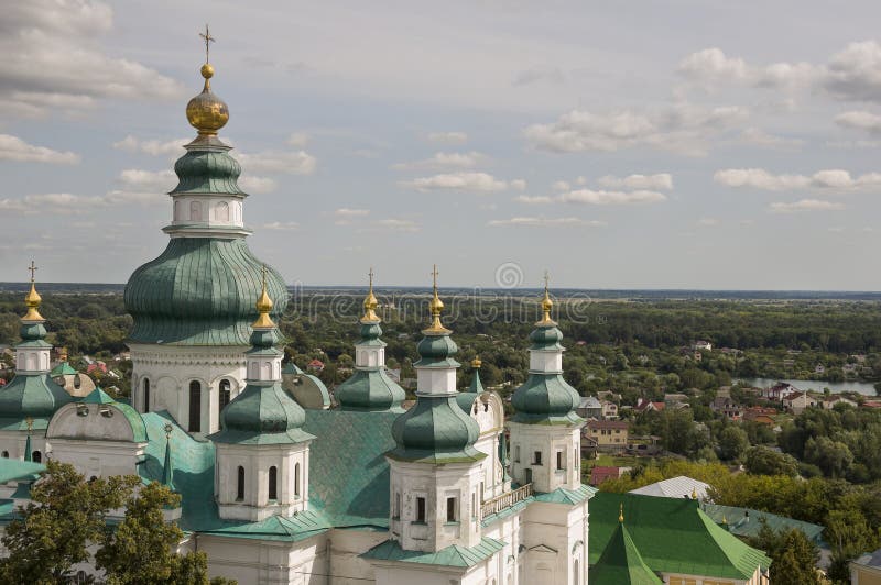 Chernigov, Ukraine. August 15, 2017. Christian orthodox white church with green domes and gold crosses. View from high. Calm sky