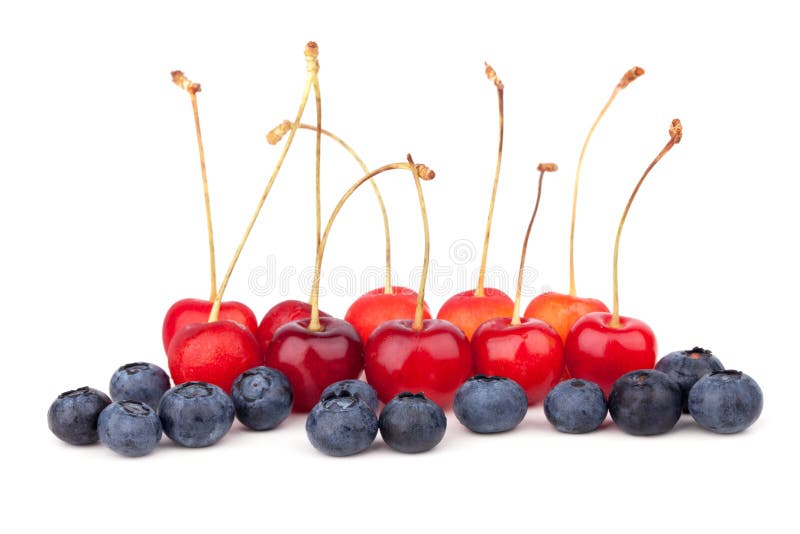 Cherries and Blueberries, Stacked in Piles, Lie on the Rolled Out Dough