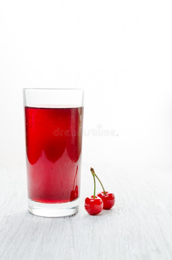 Cherries in a glass on a wooden table, Fresh drinks