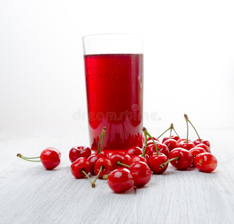 Cherries in a glass on a wooden table, Fresh drinks