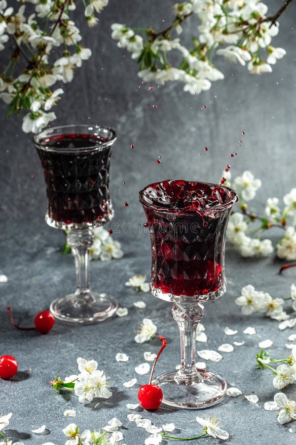 Cherry Alcoholic Drink in a Glass and Fresh Fruit, Vertical Image. Top