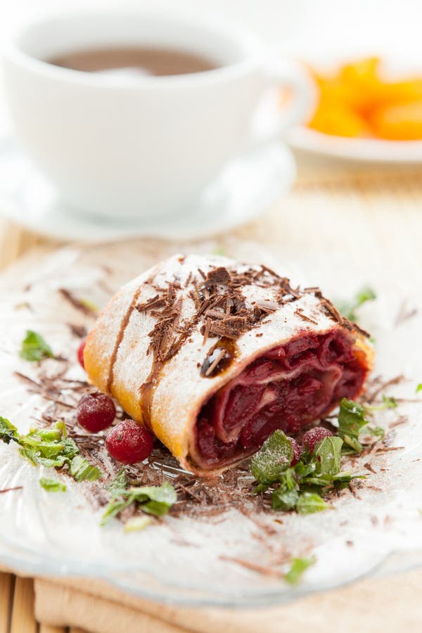 Cherry strudel with chocolate and a cup of tea