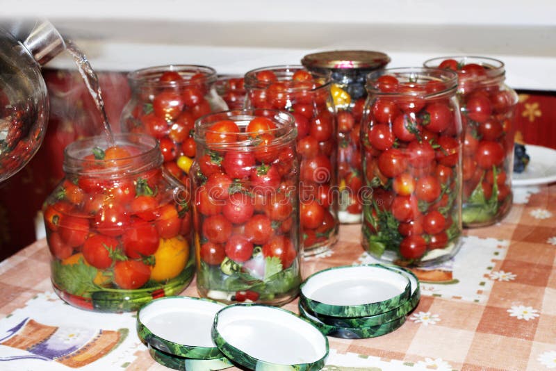 Cherry Tomatoes in the Jars Prepared for Preservation Stock Photo