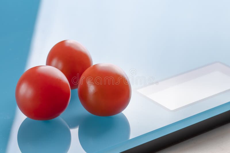 Cherry tomatoes on scales stock photo Cherry tomatoes on scales stock photo