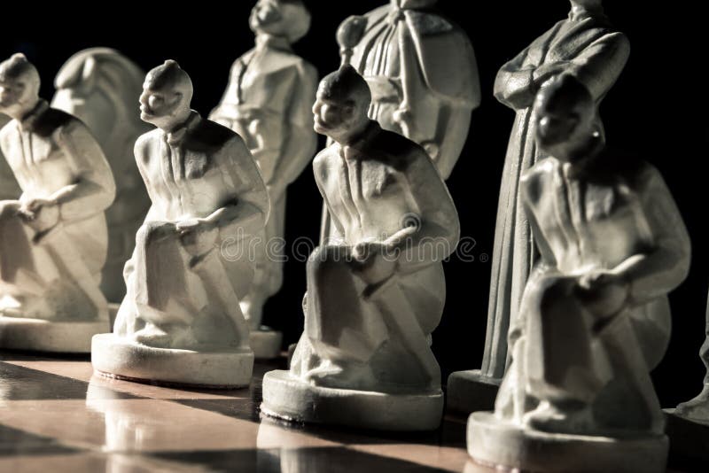Chess board. Beautiful white hand-made pawns among allied chess royalty free stock image Chess board. Beautiful white hand-made pawns among allied chess royalty free stock image