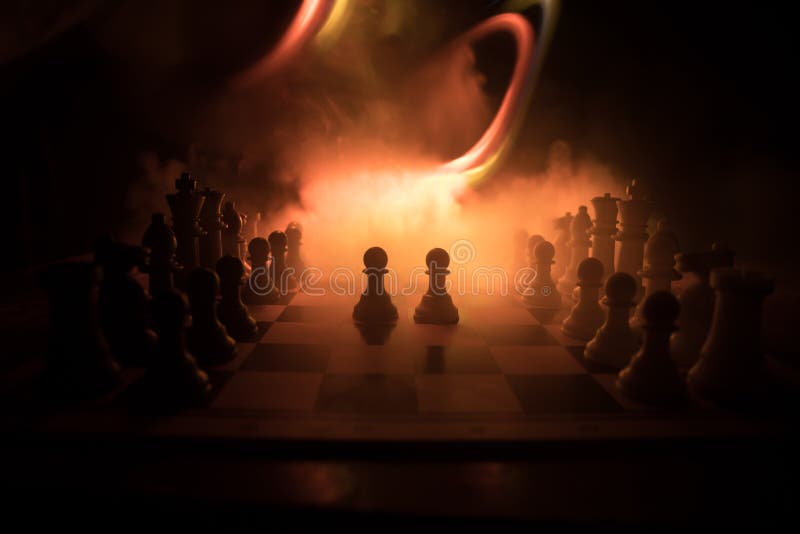 Chess figures on a dark background with smoke and fog. Epic chess