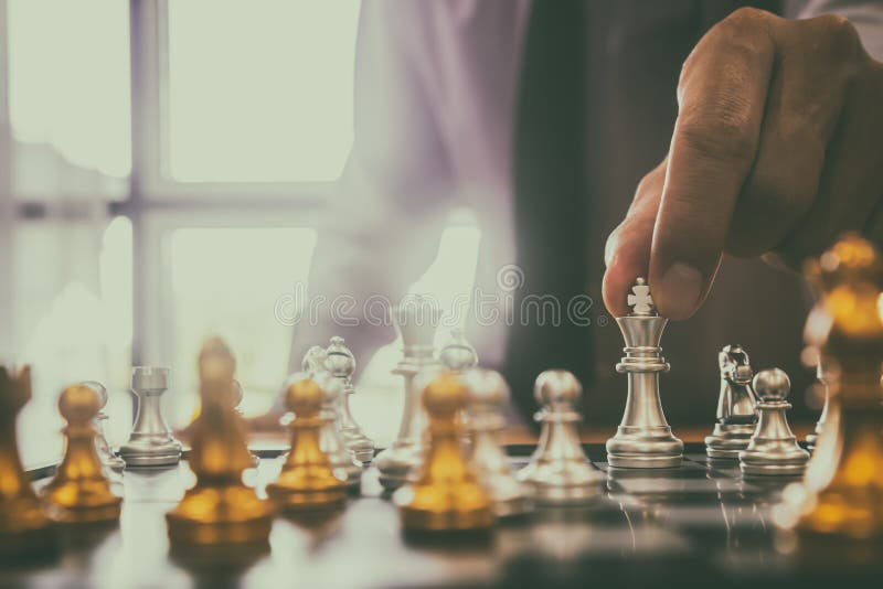 Chess game on chess board behind business man background. Business concept  to present financial information and marketing strategy analysis. Investmen  Stock Photo - Alamy