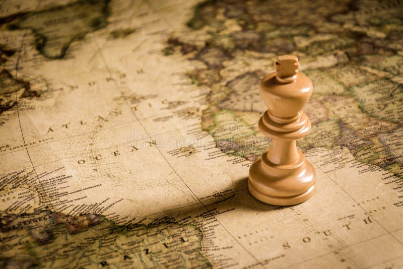 Compass and Chess on old map Stock Photo by ©kwanchaidp