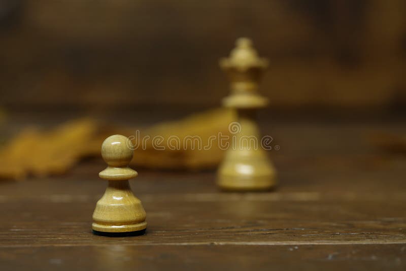 Premium Photo  Closeup of chess pieces on the chessboard under the lights  with a blurry background