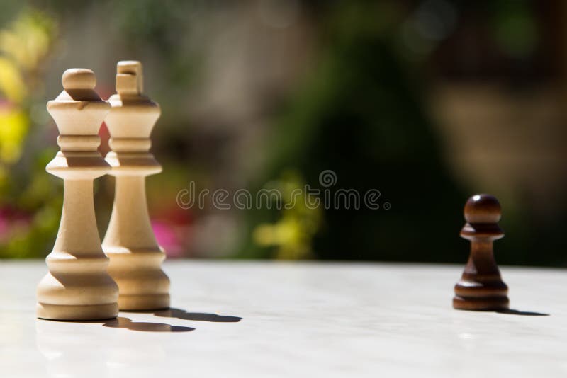 Premium Photo  Closeup of chess pieces on the chessboard under the lights  with a blurry background
