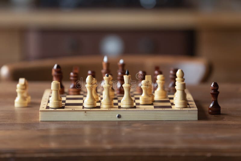 Chessboard on table in game process. Board with chess pieces