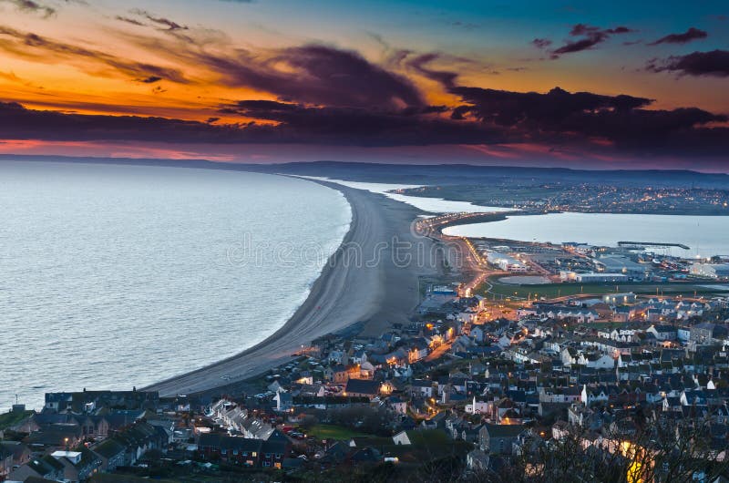 Chesil Beach. 21st August 2018. Two males enjoy swimming off Chesil Beach,  Portland, in Dorset, the