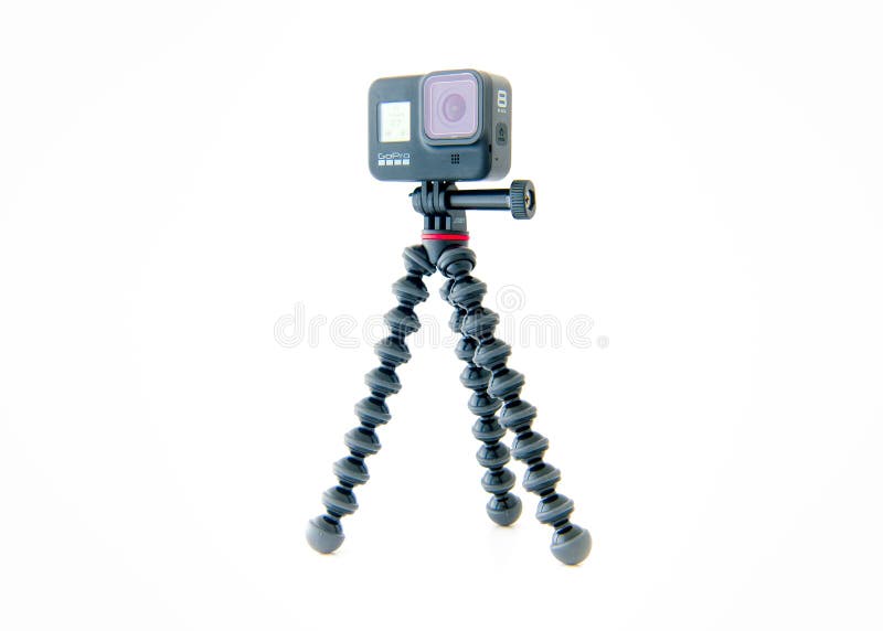 A GoPro Hero 8 Black action video camera mounted on a GorillaPod tripod from Joby. High quality photo. A GoPro Hero 8 Black action video camera mounted on a GorillaPod tripod from Joby. High quality photo