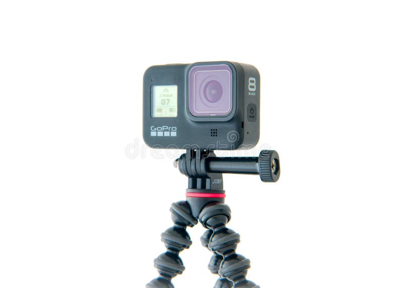 A GoPro Hero 8 Black action video camera mounted on a GorillaPod tripod from Joby. High quality photo. A GoPro Hero 8 Black action video camera mounted on a GorillaPod tripod from Joby. High quality photo