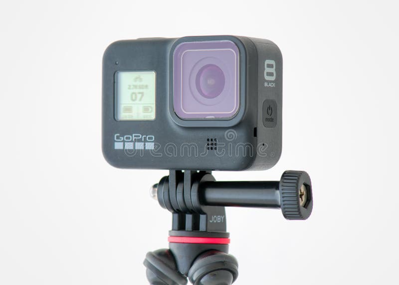 A GoPro Hero 8 Black action video camera mounted on a GorillaPod tripod from Joby. High quality photo. A GoPro Hero 8 Black action video camera mounted on a GorillaPod tripod from Joby. High quality photo