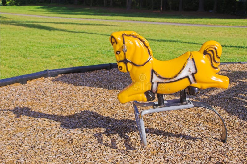 A hobby horse on an outdoor playgound in a park. A hobby horse on an outdoor playgound in a park.