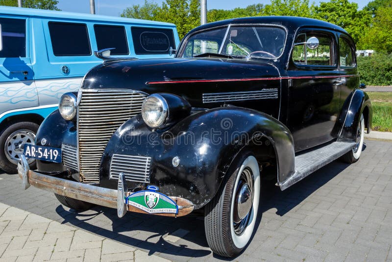 1939 Chevrolet Master Deluxe classic car on the parking lot in Rosmalen, The Netherlands - May 8, 2016 black auto automobile drive driving model old restored shining show special symbol vintage wheels nostalgia nostalgic american usa oldtimer retro