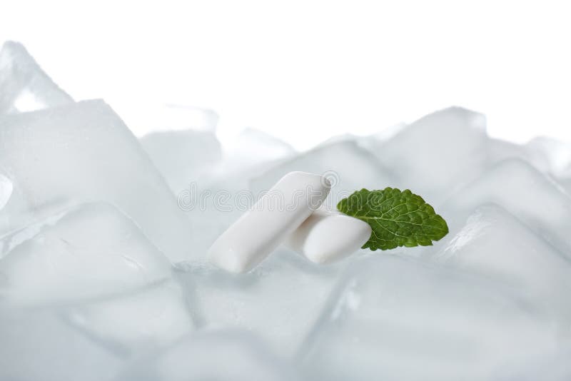 Chewing Gums and Mint on Ice Cubes Against White Background Stock Image