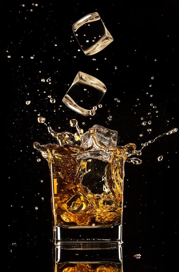 Isolated shot of whiskey with splash on black background. Isolated shot of whiskey with splash on black background