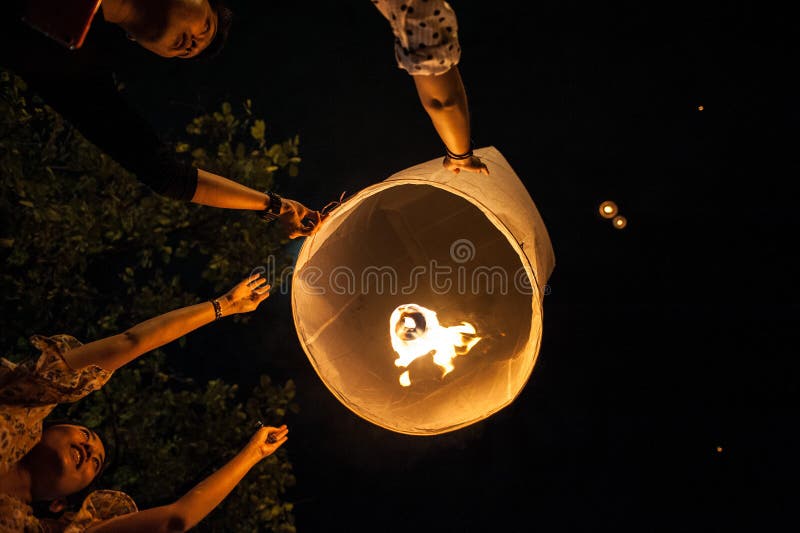 Chiang Mai, Thailand - December 31, 2017: People in crowds are launching sky lanterns, flying lanterns, floating lanterns, hot-air