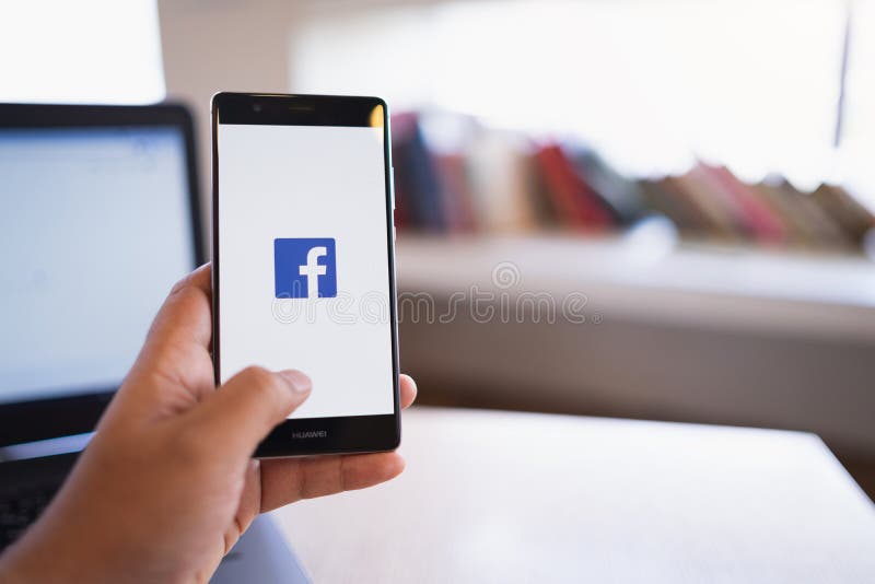 CHIANG MAI, THAILAND - June 03,2018: Man holding HUAWEI with facebook app on the screen. Facebook is a popular free social media stock photo CHIANG MAI, THAILAND - June 03,2018: Man holding HUAWEI with facebook app on the screen. Facebook is a popular free social media stock photo
