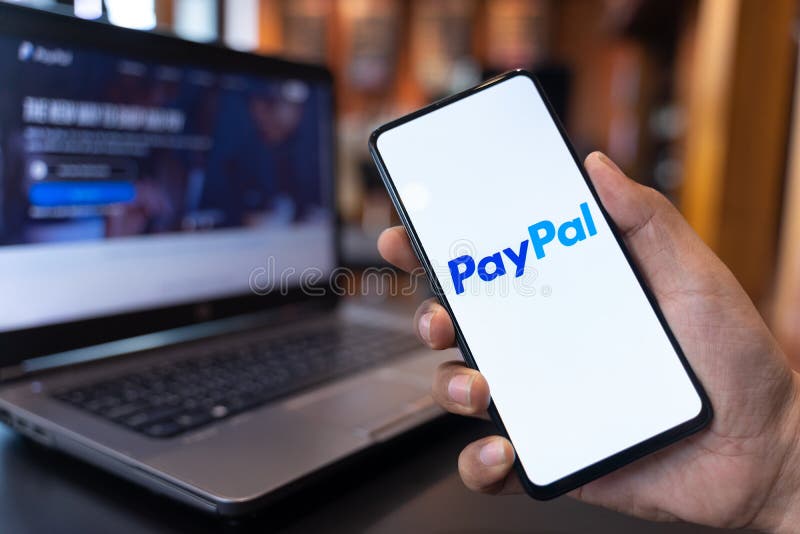 CHIANG MAI, THAILAND - May.01,2019: Man holding Xiaomi Mi Mix 3 with PayPal apps on the screen. PayPal is an online electronic