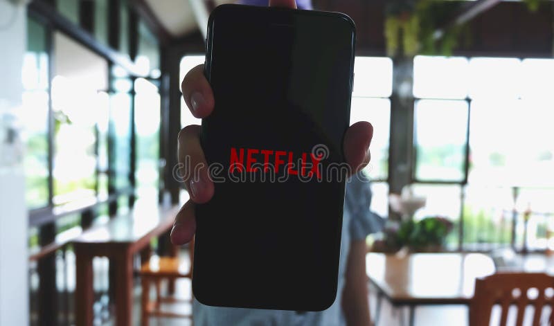 CHIANG MAI, THAILAND - May 22, 2020 : Woman hand holding Smart Phone with Netflix logo on Apple iPhone 7plus. Netflix is a global provider of streaming movies and TV series.