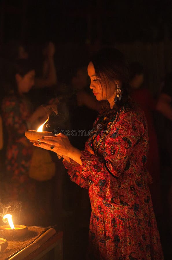 Young Asian girl light the candle to pray in Loi Krathong festival in Thailand