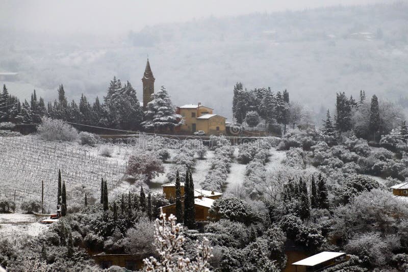 The Chianti landscape in the Tuscan hills after a winter snowfall