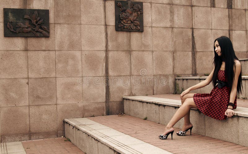 Asian modern girl is appreciating the wall decoration painting. The tone is adjusted on later stage. Asian modern girl is appreciating the wall decoration painting. The tone is adjusted on later stage.