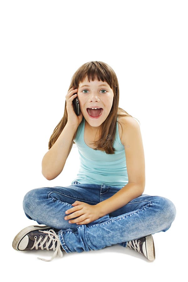Chica joven chocada que habla en el teléfono foto de archivo libre de regalías Chica joven chocada que habla en el teléfono foto de archivo libre de regalías