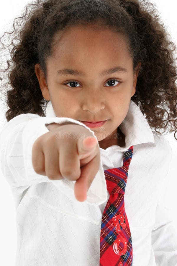 Young girl wearing a white shirt and tie pointing finger at the viewer. Young girl wearing a white shirt and tie pointing finger at the viewer.