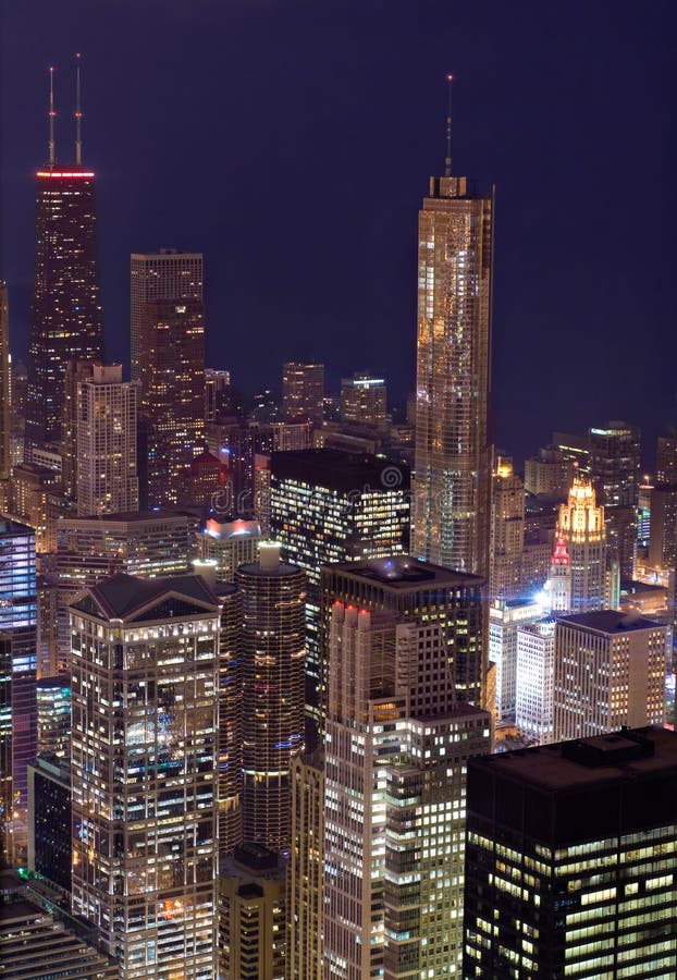 Downtown Chicago buildings glow with light at twilight. Downtown Chicago buildings glow with light at twilight